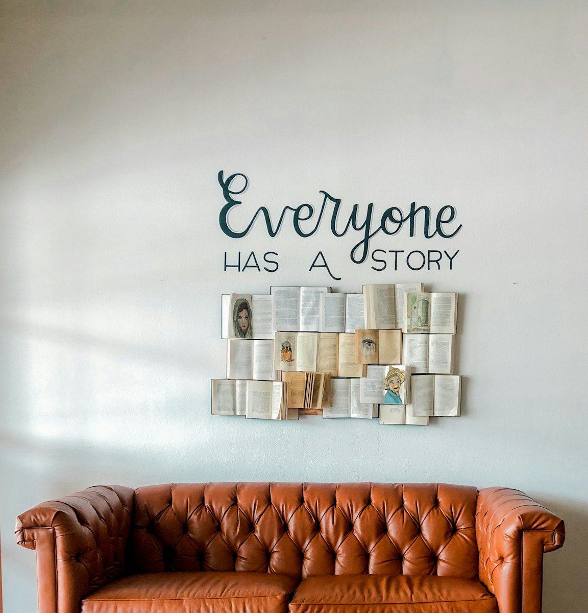 Photo by Maegan Martin a brown leather couch sitting in front of a white wall